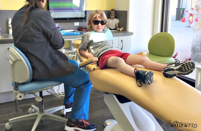 Picture-of-small-child-in-dentist-chair-for-national-children-dental-health-month-awareness